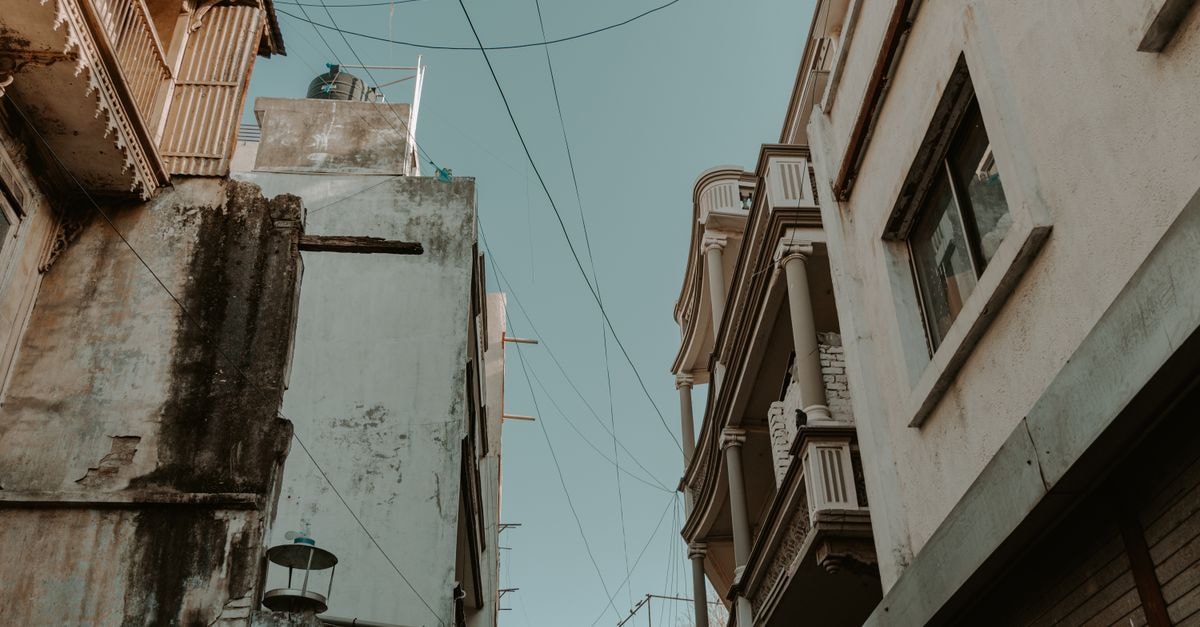 Good Night in Ahmedabad: A 20-Year Old City-Centre Stay Near Manek Chowk A low angle shot of residential architecture in Ahmedabad, showcasing urban heritage and old structures.