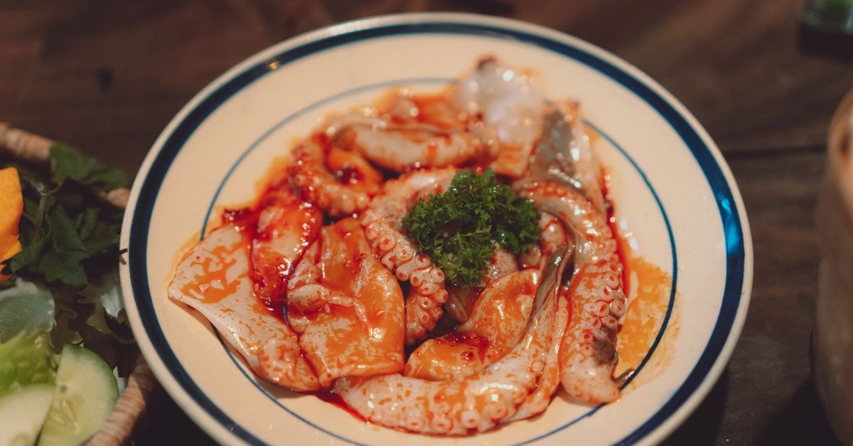 Yeosu July 2026 Travel Guide: Expo Countdown, Octopus Festival and Coastal Seafood Close-up of a deliciously plated seafood dish featuring octopus in Dalat, Vietnam.