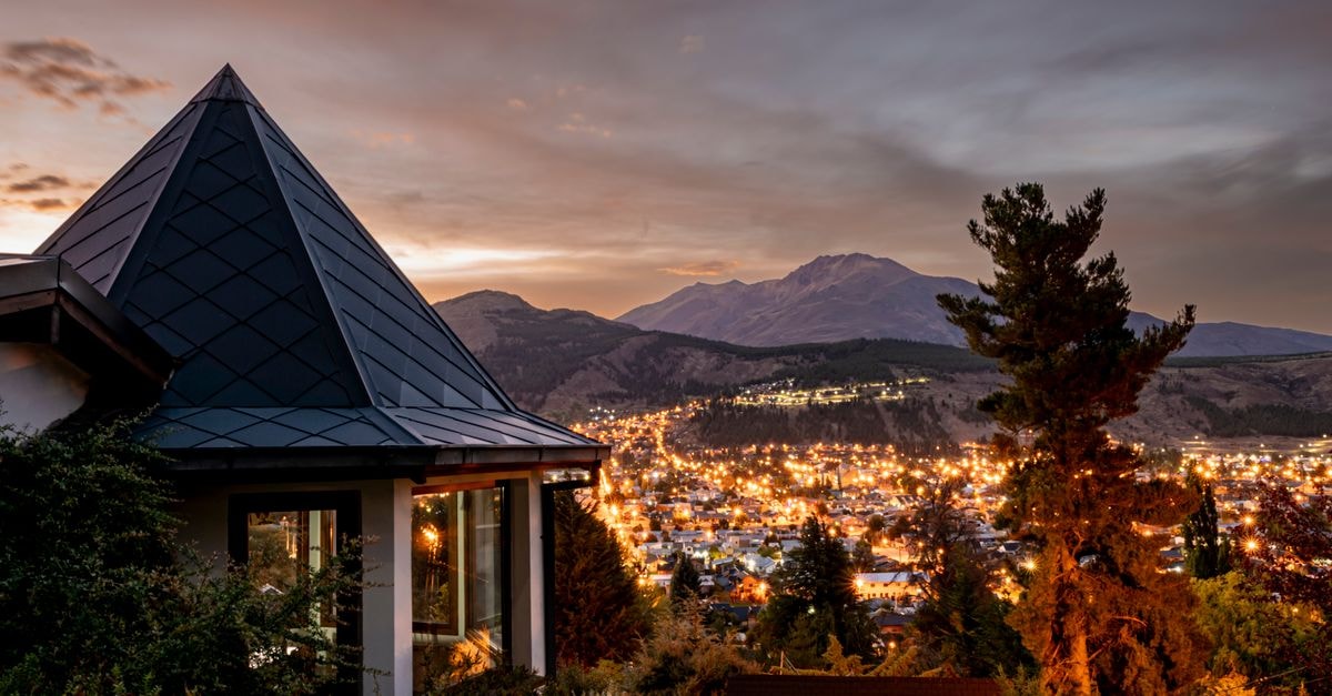 Hotel Ybyturuzu in Villarrica: A Tranquil Base Near Paraguay's Highest Range Beautiful twilight scene over Esquel, Argentina with lights of the town and mountains.