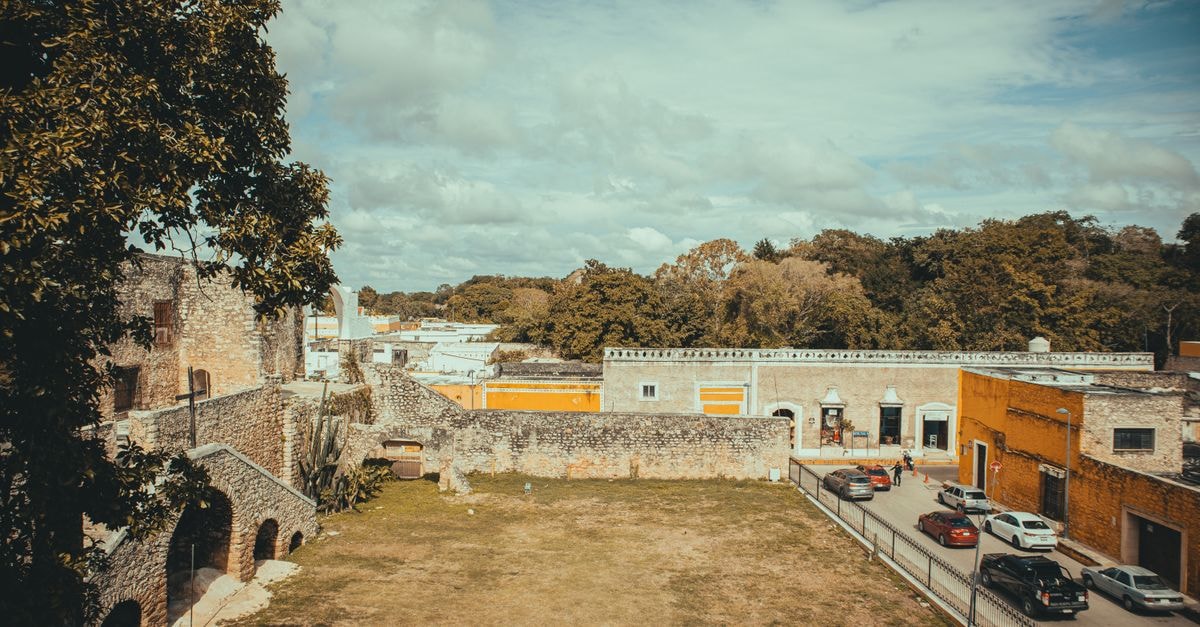 Hotel La Pedregosa, Mérida — Andean Stay with Pool, Garden and Andean Air A scenic aerial view of a historic area with ancient buildings and a bustling street.