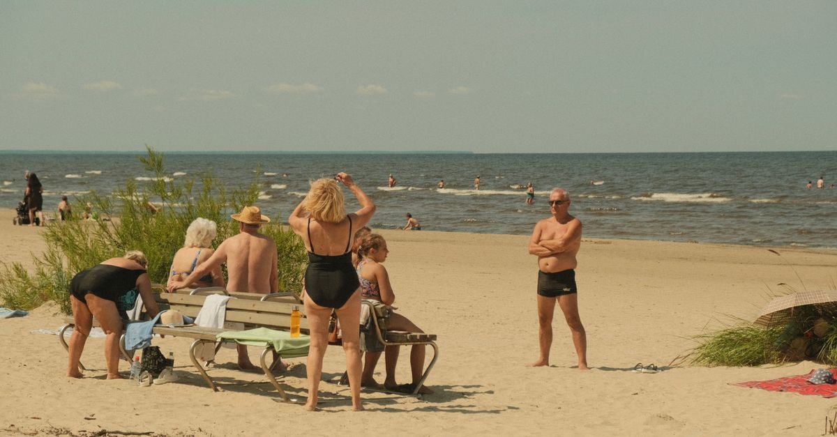 一群人在拉脫維亞 Jūrmala 的海灘上享受晴朗的一天。