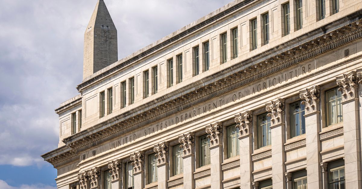 Moonshot's Kimi K3 reshapes US-China AI contest as Microsoft and Washington weigh responses US Department of Agriculture building with Washington Monument behind, blue sky with clouds.
