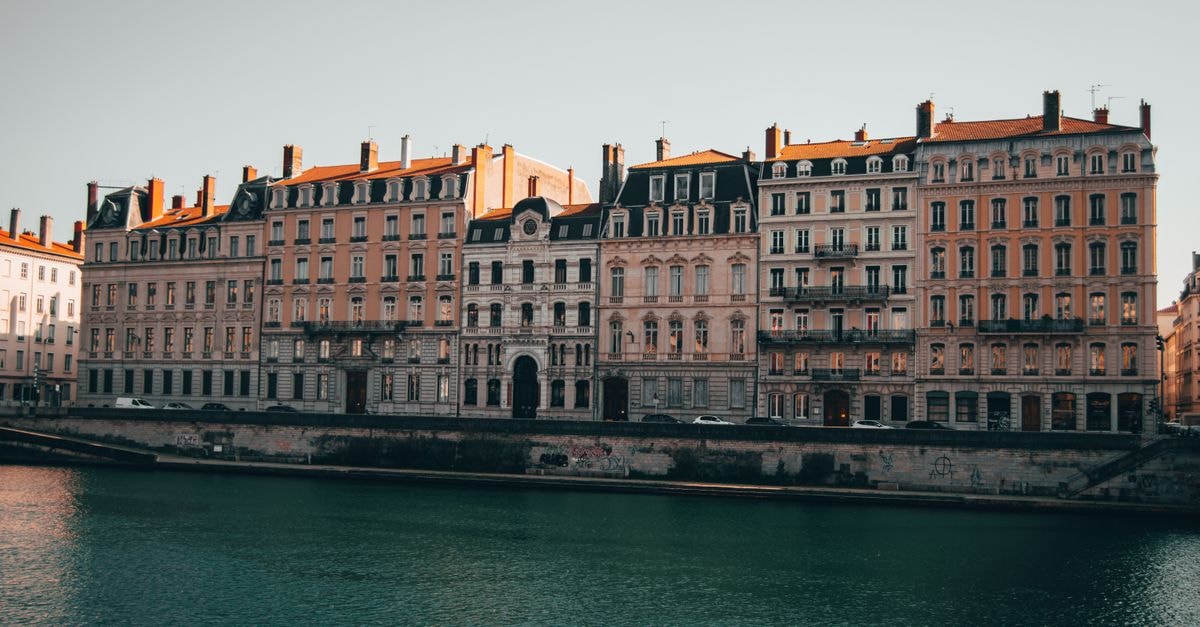 Charming view of historic buildings lining the Rhône River in Lyon, France.