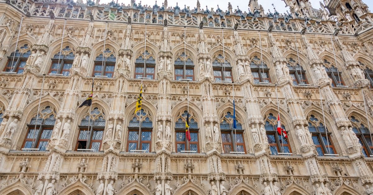 Martin's Klooster in Leuven: A Heritage Address in the Old Town Detailed view of the ornate Gothic facade of Leuven Town Hall, a famous landmark in Belgium.