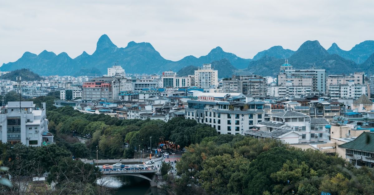 Ji Hotel Huangshi: A Practical Stop Near the North Station A beautiful aerial view of a city with lush greenery and prominent hills in the background.