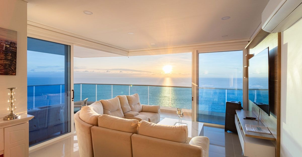 Contemporary living room with ocean view in Santa Marta, Colombia, at sunset.