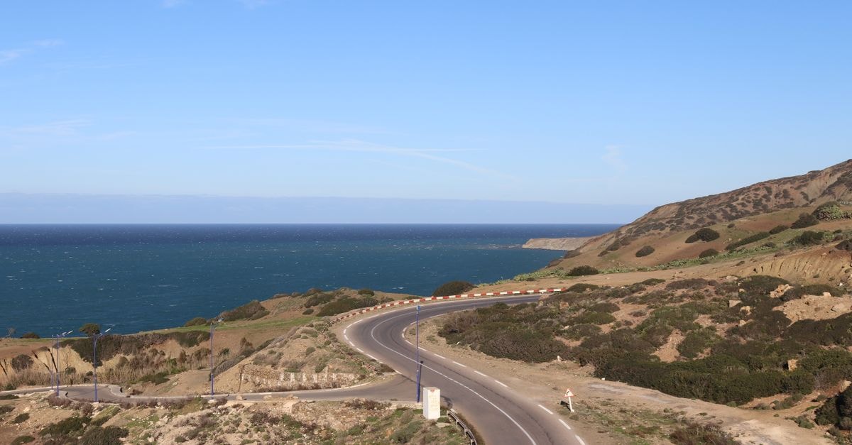 Explore the winding coastal road with ocean views in Mostaganem, Algeria.