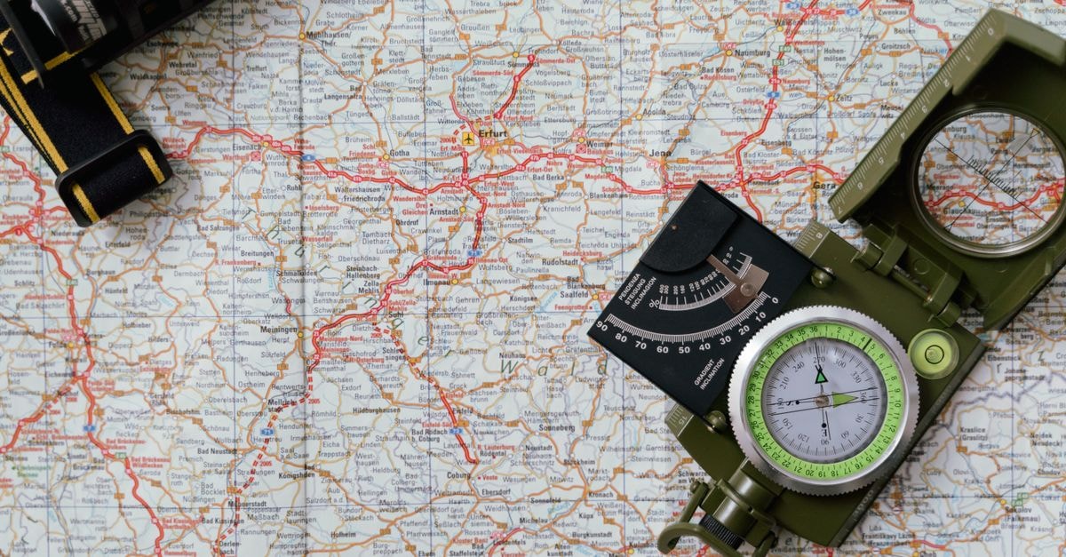 Regina Travel Guide: Planning Tips, Costs and Things to Do Close-up view of a compass on a detailed map, ideal for travel and navigation concepts.