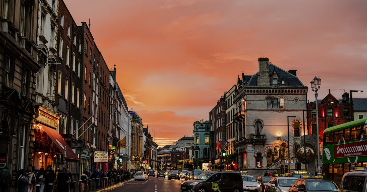 Vibrant city street in Dublin, Ireland during a stunning sunset, showcasing urban life.