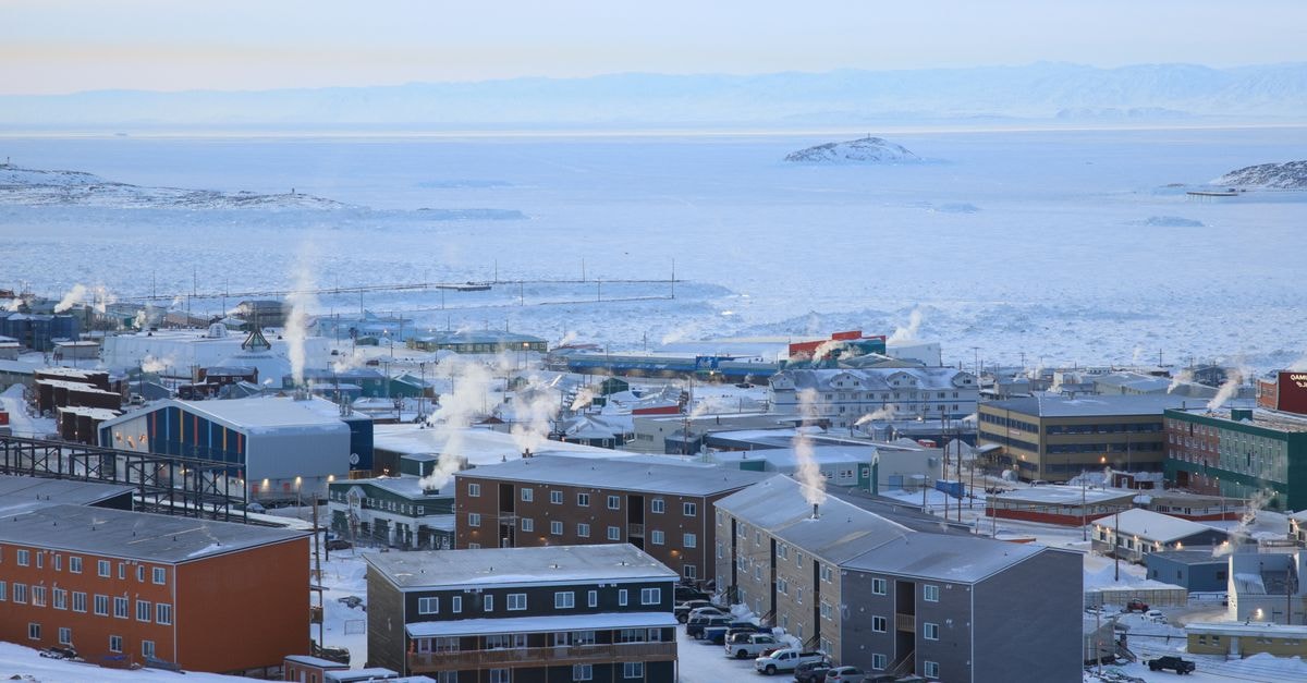 Anadyr, Chukotka: An Arctic Travel Guide for the Curious A panoramic winter view of Iqaluit, Nunavut, capturing arctic architecture in a snowy landscape.