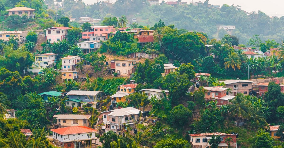 Rio Claro travel guide: a slow, breezy corner of Trinidad's east coast A vibrant hillside neighborhood in Port of Spain, Trinidad and Tobago, surrounded by lush greenery.