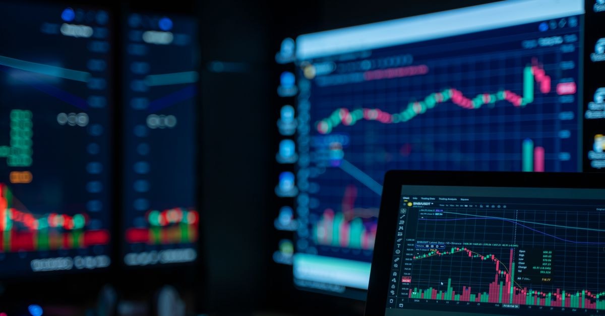 Institutional Investors Reshape Cisco Stakes in Q2 Filings Monitors displaying stock market charts in a dimly lit room, perfect for finance and trading themes.
