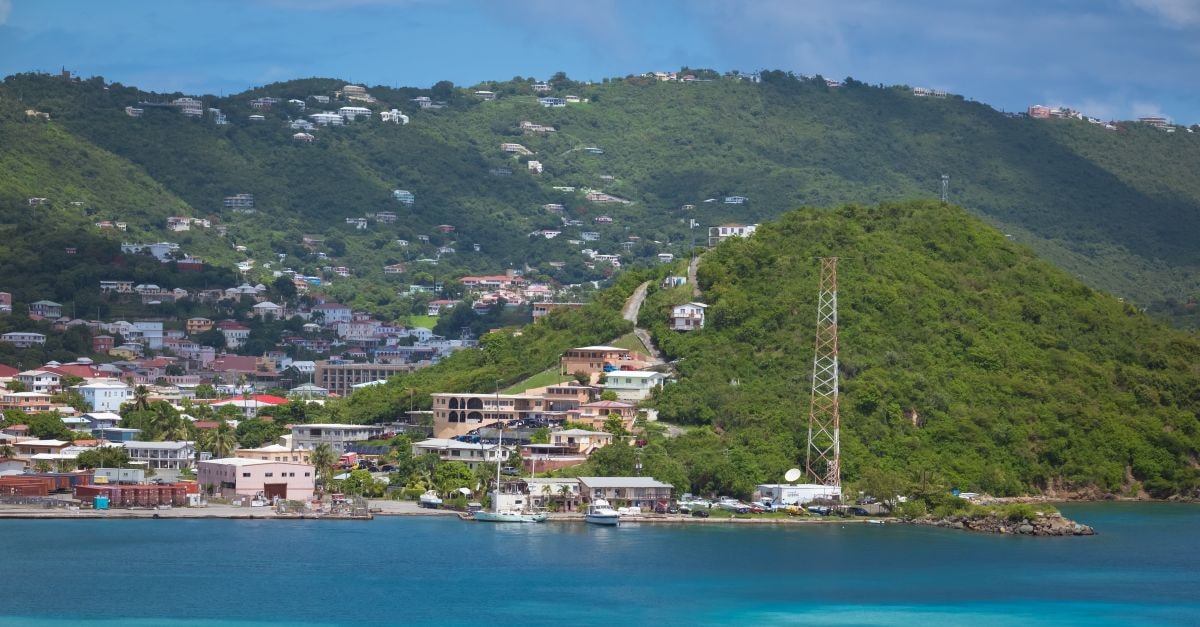 Castries Travel Guide: Island Color, Markets, and Easy Walking Routes A picturesque coastal scene featuring lush green hills and vibrant turquoise waters.