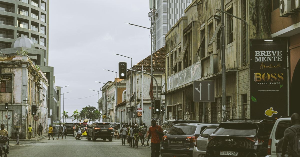 Abidjan Travel Guide: Planning Tips, Costs and Things to Do Bustling street scene in downtown Luanda, Angola with historic and modern buildings.