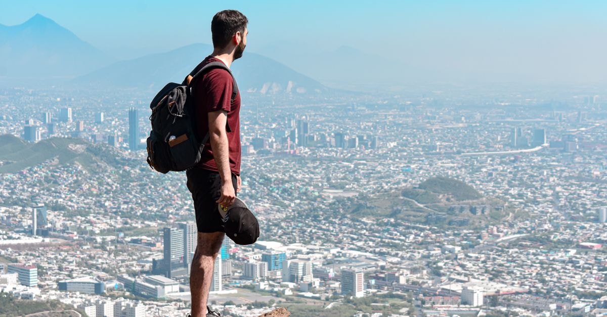 Monterrey Travel Guide: Getting Around, Eating Well, and Planning Smart A man standing on a rock, overlooking the scenic cityscape of Monterrey, México.