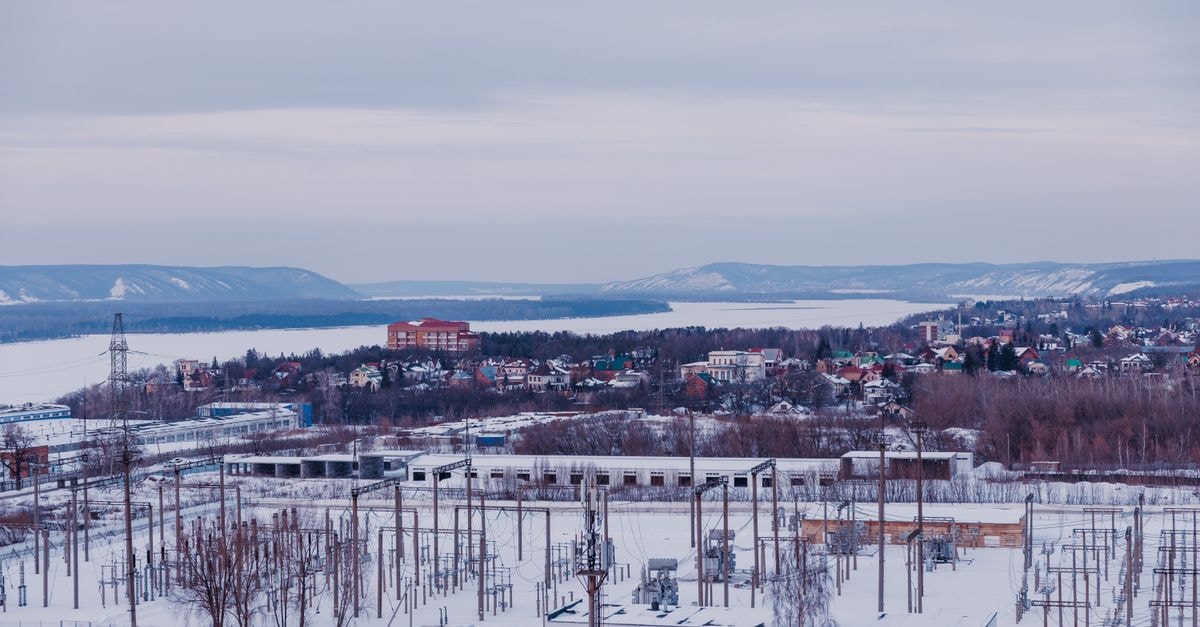 Aist in Nizhny Tagil: A Specialty Stay on Dolgaya Street Snow-covered suburban landscape with power lines and distant hills.