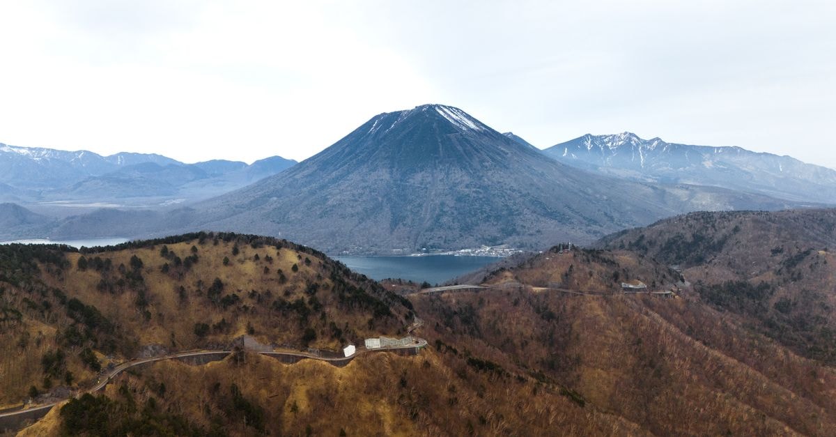 Stay Nikko Guesthouse, Nikko — A Refurbished Japanese House with River and Mountain Views Stunning aerial view of Mount Nantai with Lake Chuzenji in Nikko, Japan.