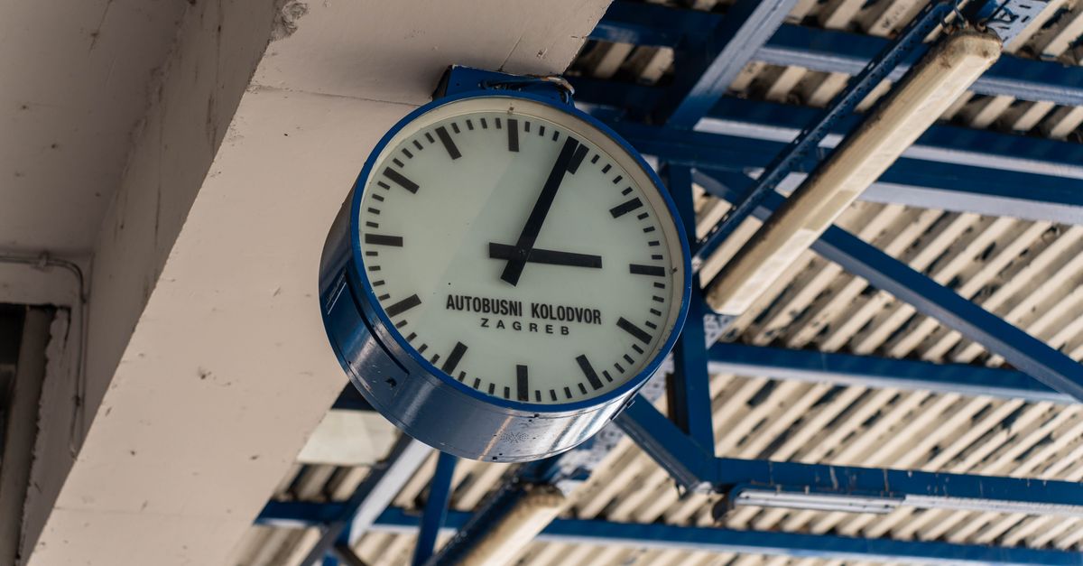 Zagreb Travel Guide: July 2026 Weather, Folklore Festival and Costs A wall-mounted clock at the Zagreb bus station showing time, under a metallic ceiling.