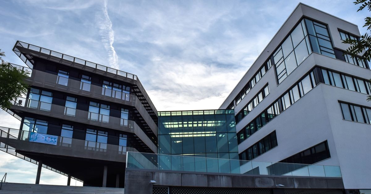 Artesian Resources: Regulated Water Utility With High Capex and Negative Free Cash Flow A modern glass-facade building against a blue sky, featuring innovative architecture.