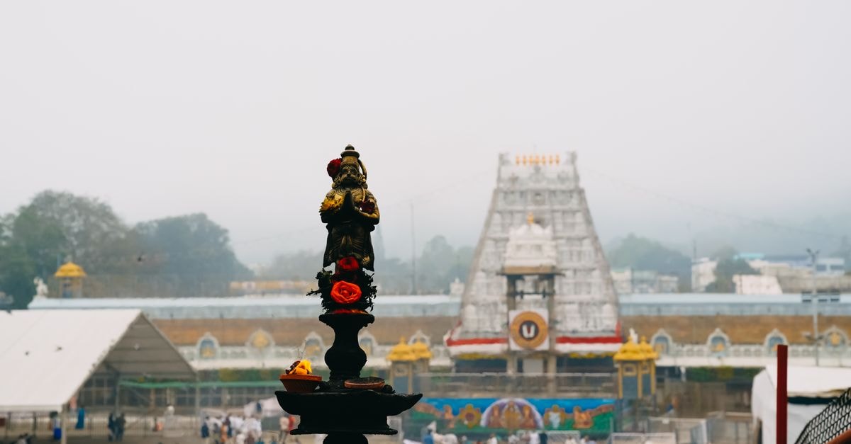Vijayawada Travel Guide: Planning Tips, Costs and Things to Do View of Tirupati Temple with a traditional oil lamp in the foreground, capturing the essence of Indian spirituality.