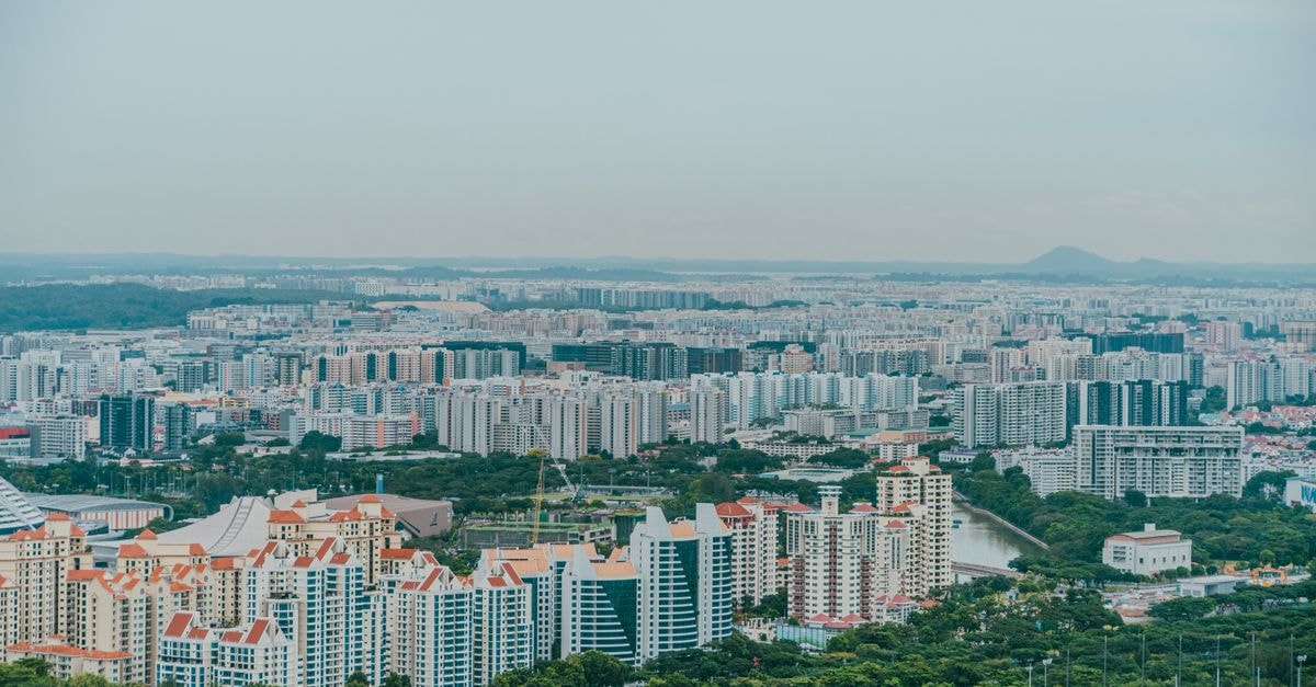 Amari Johor Bahru in Woodlands: A Bright Stopover Near the City Buzz A panoramic aerial view showcasing the dense urban sprawl of Singapore's skyline with modern architecture.