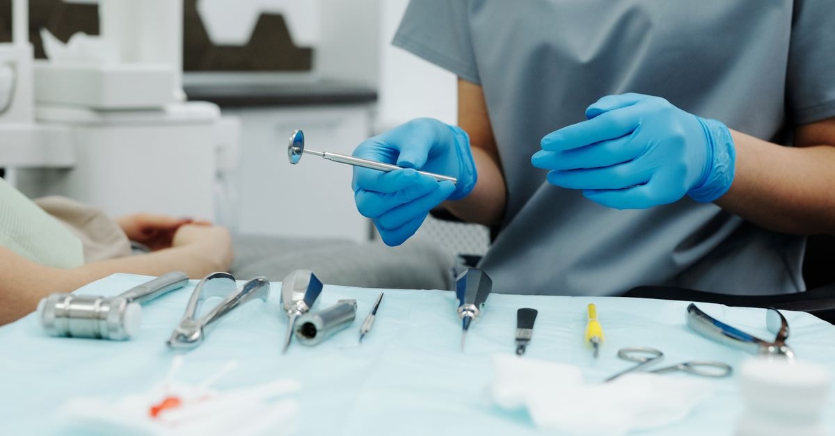 InspireMD at a Going-Concern Crossroads: A Small-Cap Vascular Stent Story Still Burning Cash Dentist with gloves organizing instruments in a clinic setting, ready for a dental procedure.
