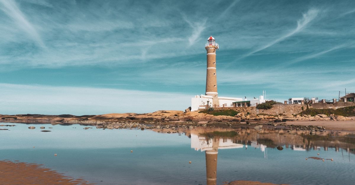 Rivera, Uruguay Travel Guide: A Border City Worth a Slow Pause Beautiful seaside view of Faro de José Ignacio lighthouse reflecting in the calm water.