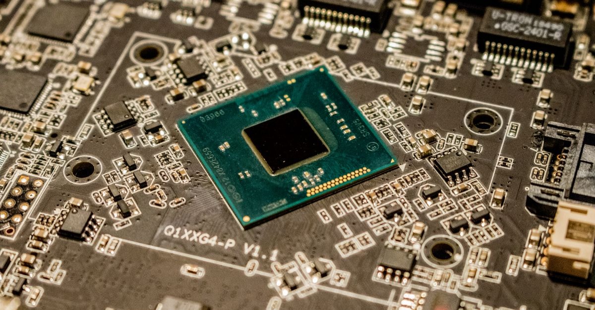 Samsung Posts Record Q2 Profit, Warns Chip Shortage to Extend Through 2028 Detailed view of a microchip on a printed circuit board, showcasing electronic components.
