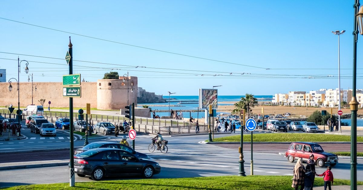 Vibrant street scene in Rabat, Morocco, with historical architecture and coastal view.