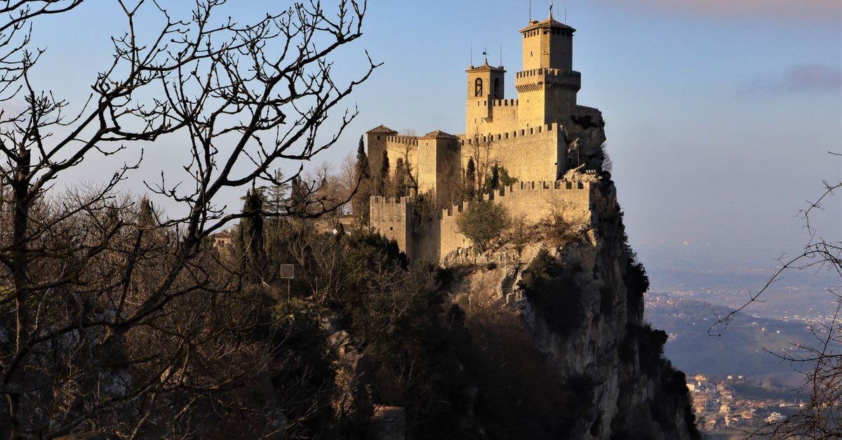 A Quiet, Hilltop Republic: A Travel Guide to San Marino Stunning image of the ancient Guaita Tower in San Marino set against a winter landscape.