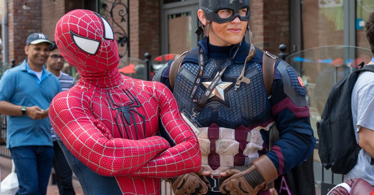 Sony Dated God of War Laufey and Debuted Marvel's Wolverine Trailer at San Diego Comic-Con as PSN Recovered From Outage Spider-Man and Captain America cosplayers pose in a lively street scene with onlookers.