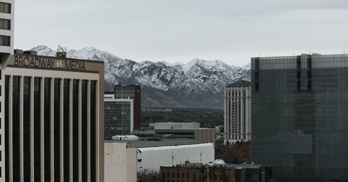Hilton Salt Lake City Center: Downtown Convention District Base Salt Lake City's urban skyline with snow-capped mountains in the background.