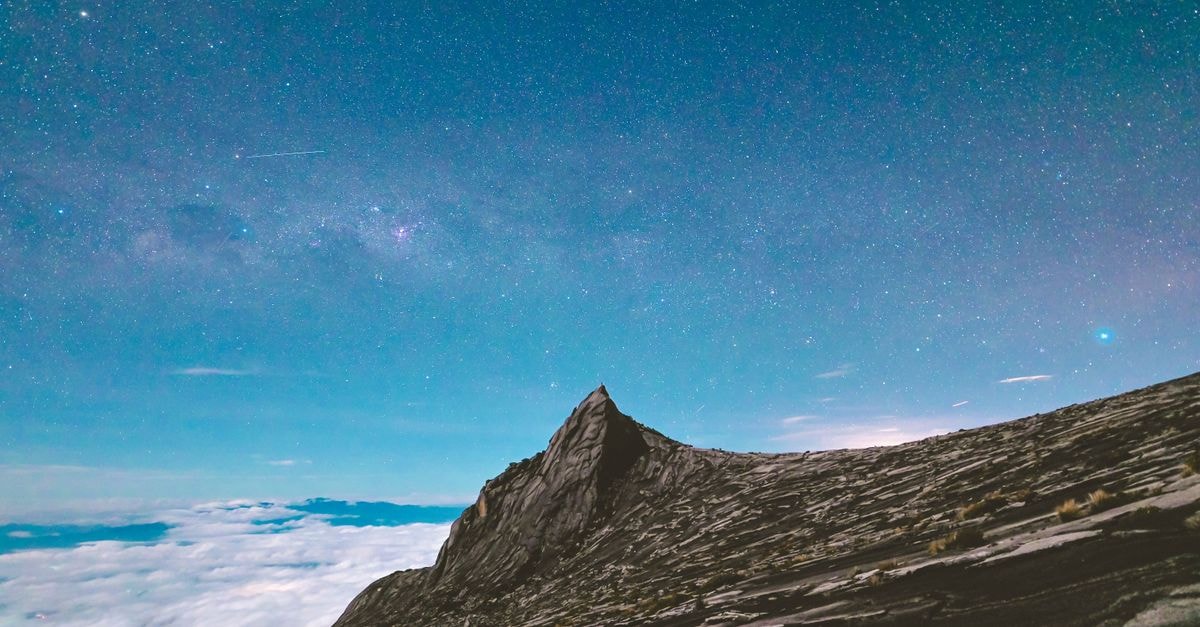 Hilton Kota Kinabalu: Kota Kinabalu's First Hilton Since 2017 Capture the magic of Mount Kinabalu's peak against a vibrant night sky filled with stars.