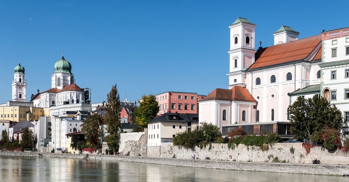 Linz Travel Guide: Planning Tips, Costs and Things to Do Charming view of Passau's historical center along the tranquil Danube River in Germany.