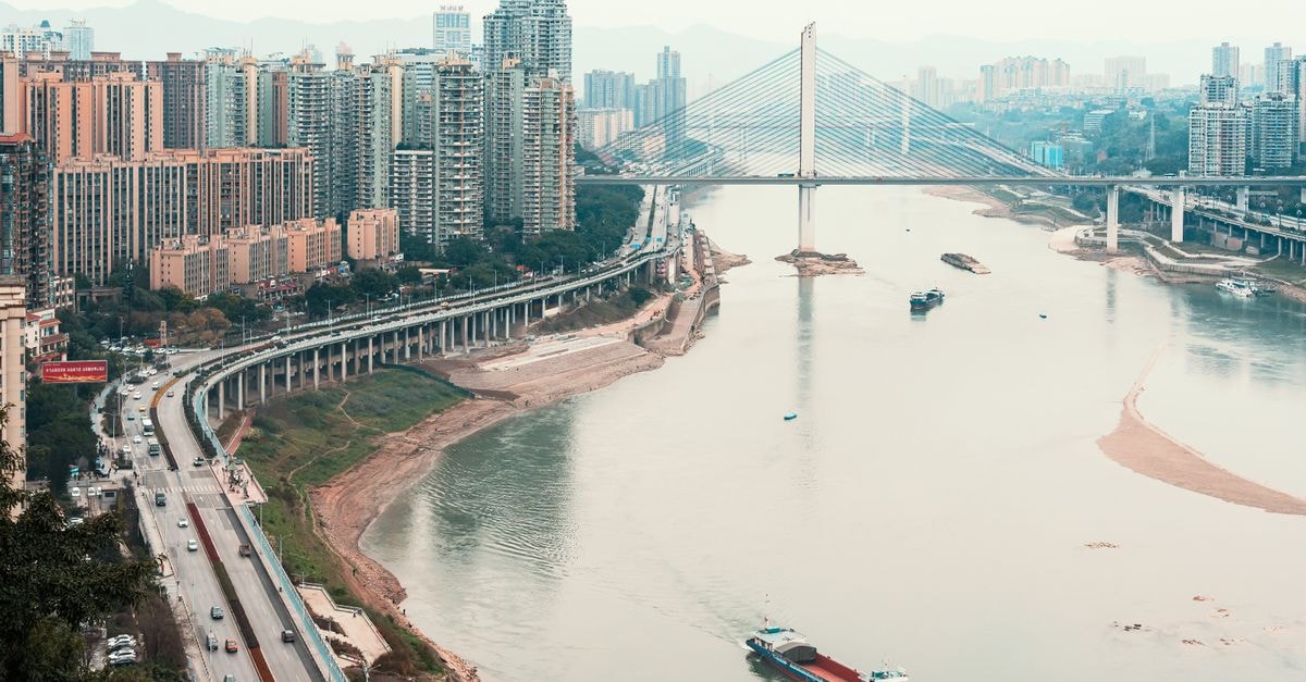 Super 8 Hotel Chongqing Shi Qiao Pu: A Practical Stay in the Hi-Tech Zone Cityscape with modern skyline, bridge, and river in daylight