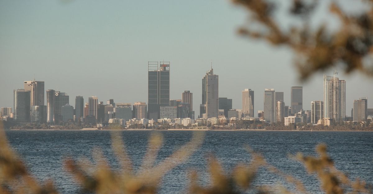 Royal Lodge, Wa: A Practical Stay in Ghana's Upper West View of Perth skyline across water framed by foliage with a calm atmosphere at dusk.
