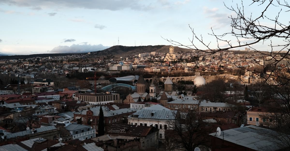 Sunny Hill Center, Arta: A Pit-Stop on Route Nationale 4 A panoramic view of Tbilisi showcasing historic architecture and vibrant urban life.