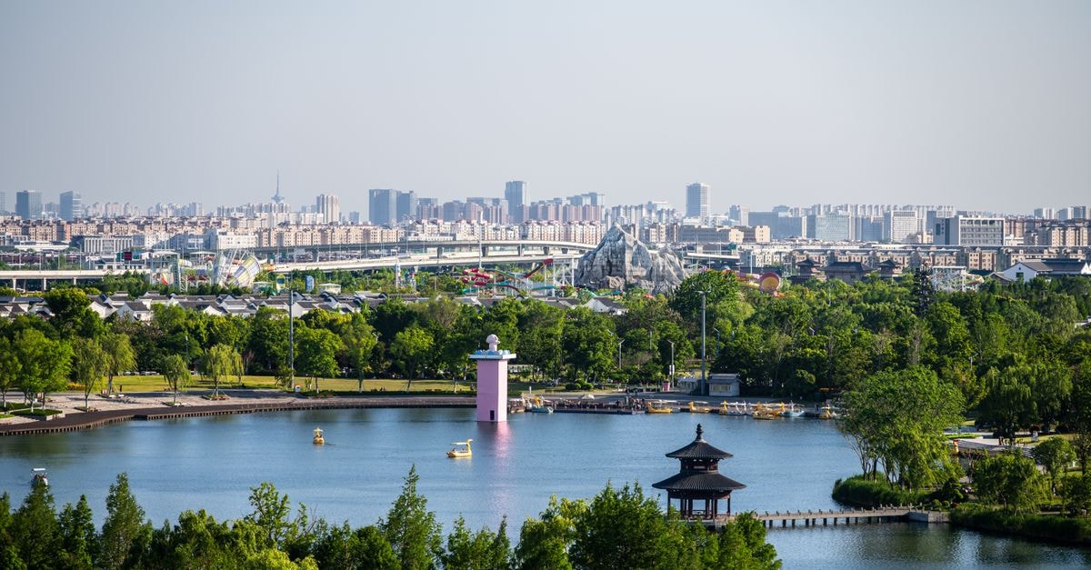 Jinjiang Inn in Taiyuan: A Yingze Subdistrict Address Surrounded by Mapped Eateries Aerial view of Yangcheng Lake Park in Yancheng, Jiangsu, featuring lush greenery and city skyline background.