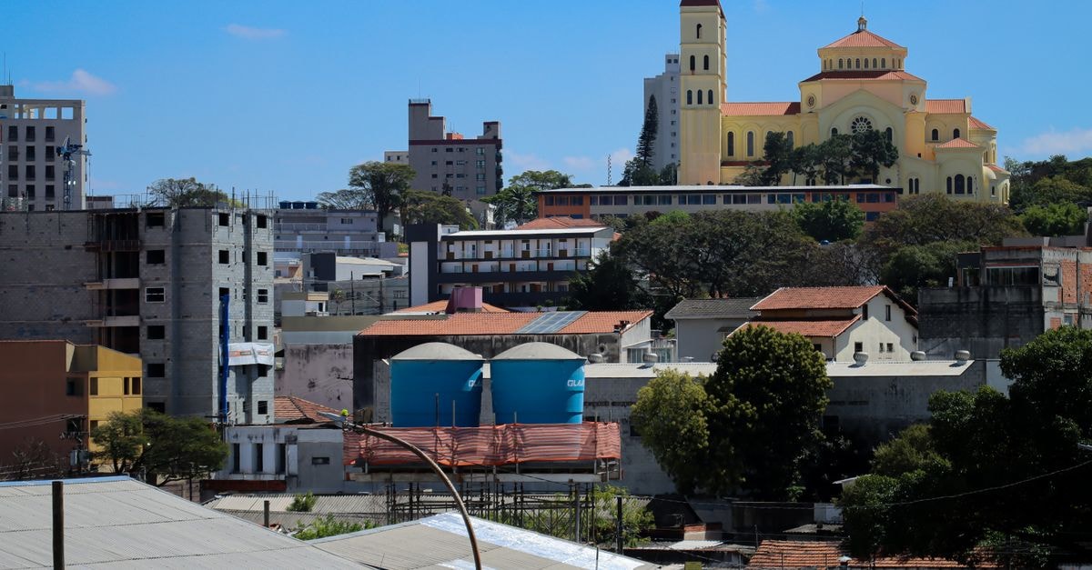 Urban skyline featuring a historic church and vibrant buildings under a clear sky.