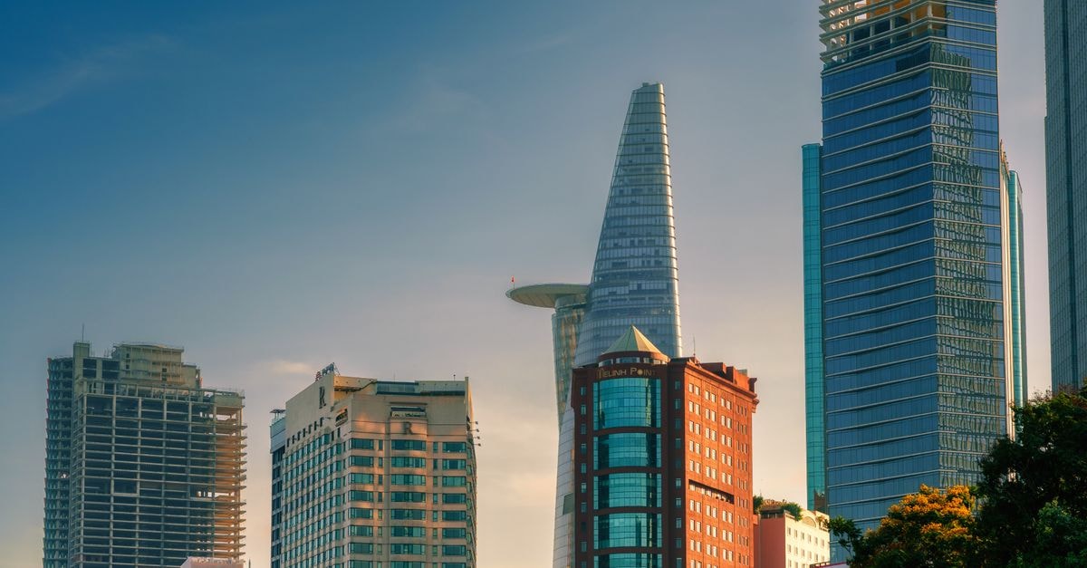A stunning view of Ho Chi Minh City's skyline featuring Bitexco Financial Tower at sunset.