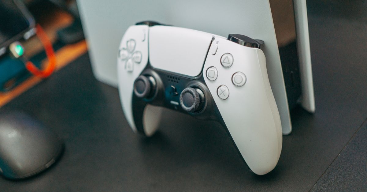 Sony braces for GTA VI PS5 lift while weighing memory-chip costs Close-up of a PlayStation 5 controller resting on its console, showcasing modern gaming technology.