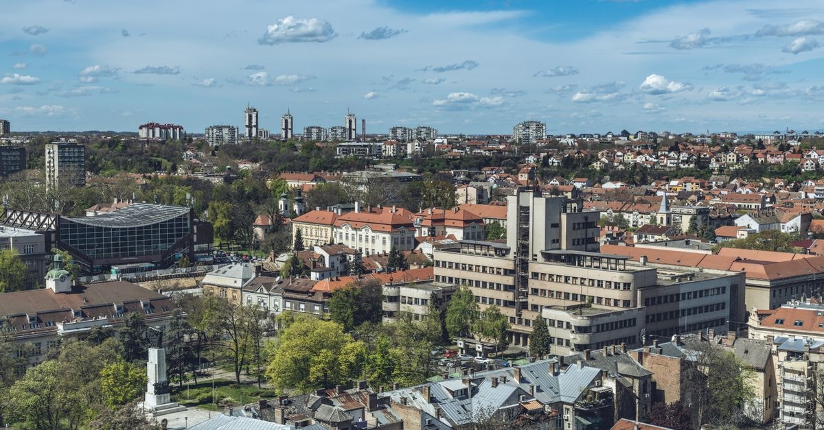 Qubus Hotel Kielce: A Central Stay on Składowa Street A panoramic aerial view of the cityscape of Belgrade, Serbia, showcasing urban architecture under a blue sky.