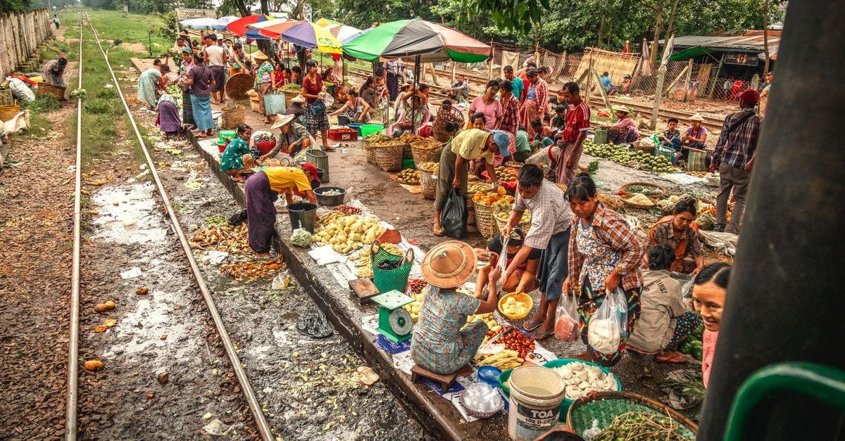 Linfen Travel Guide: Weather, Trains and Food Culture Bustling street market by railway in Yangon, Myanmar, showcasing local culture and commerce.