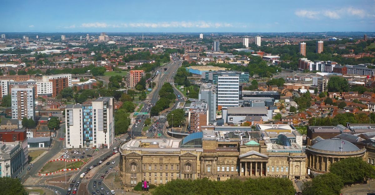 Travelodge, Liverpool: A Practical Stop on Edge Lane Stunning aerial view of Liverpool cityscape featuring historical architecture and modern buildings.