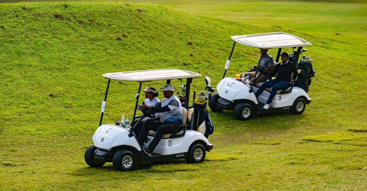 Golfe, Luanda Travel Guide: Settlements, Climate, and Angolan Flavors Golfers enjoying a day on the course in Piggs Peak, Eswatini, riding in golf carts.