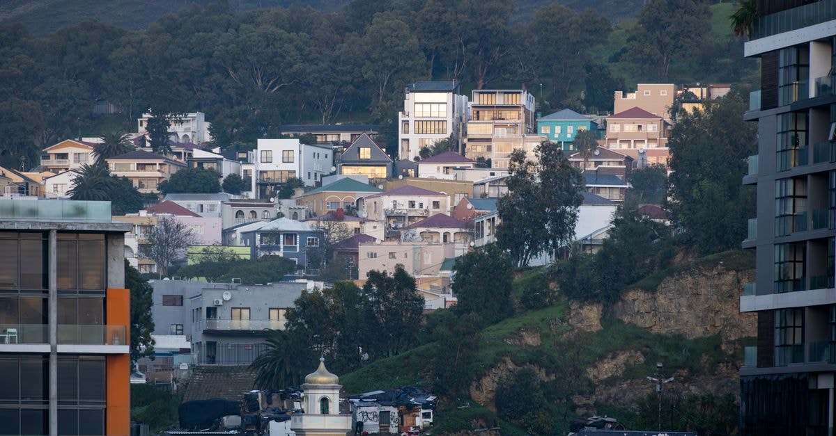 Hilton Garden Inn Windhoek, Namibia — A Central City Stay A serene view of a hillside urban neighborhood with diverse houses nestled among trees during the day.