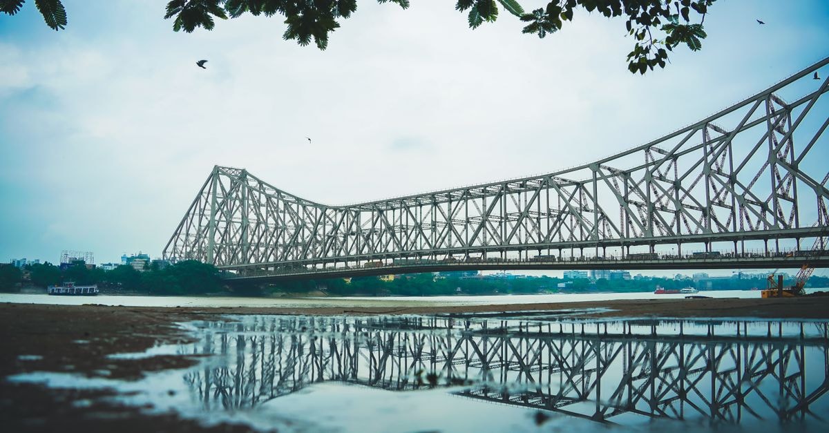 Stunning view of Howrah Bridge with reflection. Frame the scenic beauty from Kolkata.