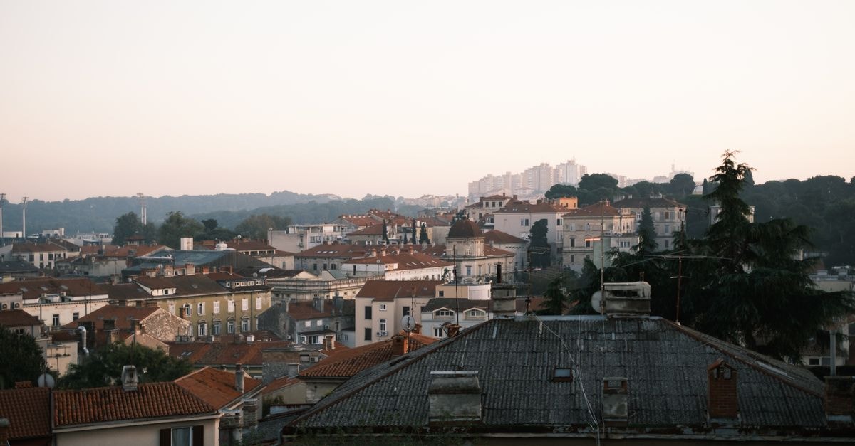 Hotel Amfiteatar, Pula — A Boutique Stay Inside the Old Town A picturesque view of Pula's rooftops at dusk in Istria County, Croatia.