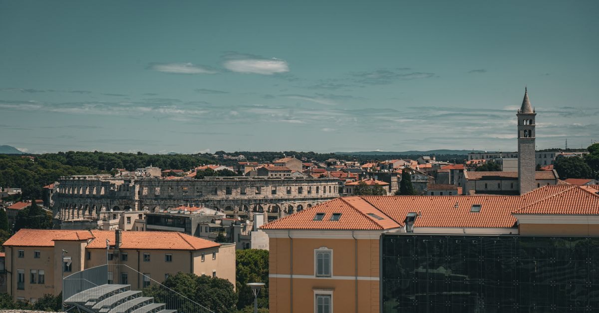 Hostel Monte Zaro in Pula: A Modern Stay on a Historic Hill A picturesque aerial view of Pula, Croatia, featuring the historic Roman amphitheater.