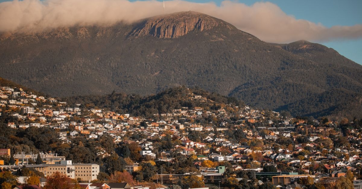 Quest on Johnston in Wellington: Central CBD Serviced Apartments Scenic aerial shot of Hobart, Tasmania, featuring Mount Wellington looming in the background.